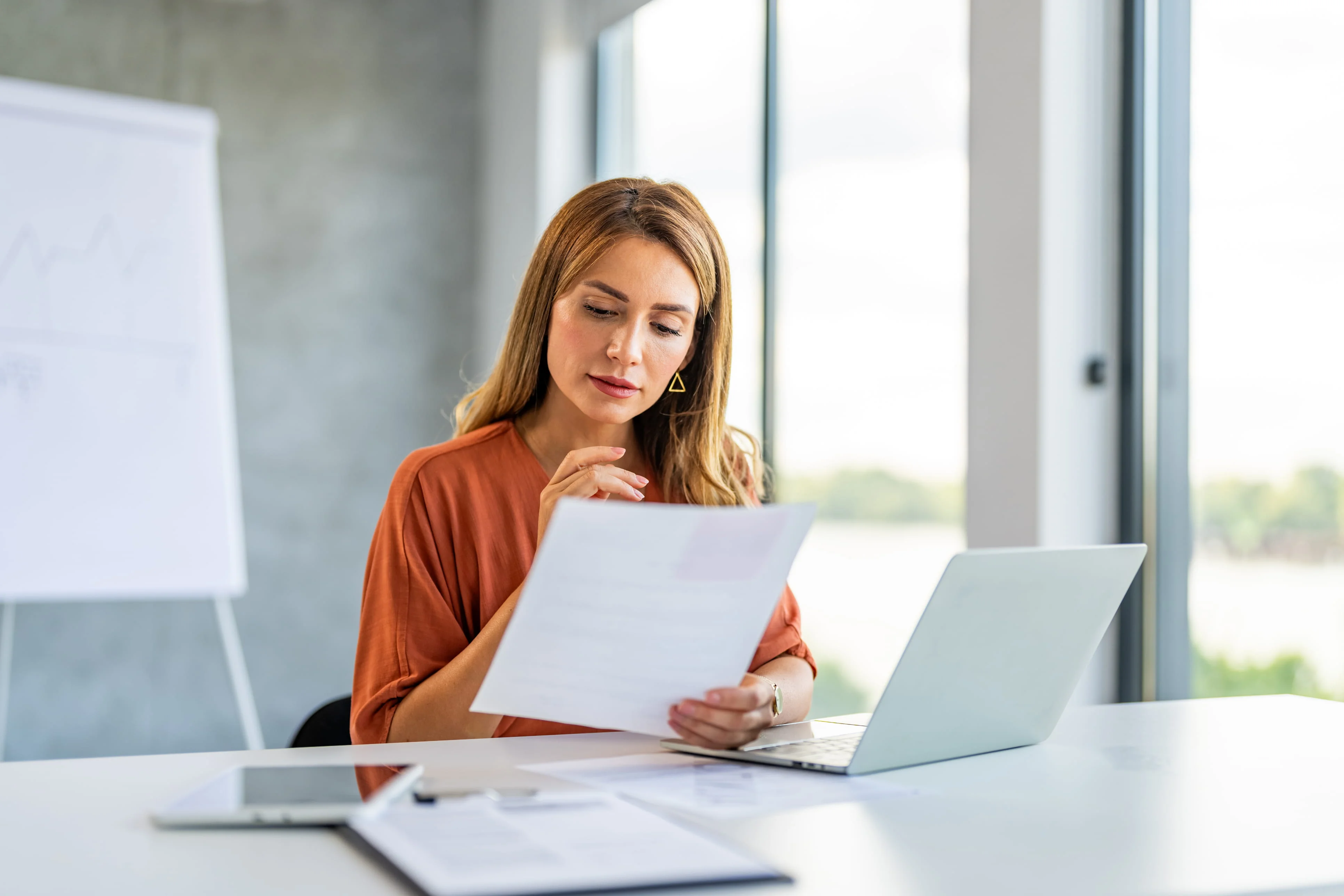 Professional matchmaking consultant analyzing documents at her desk
