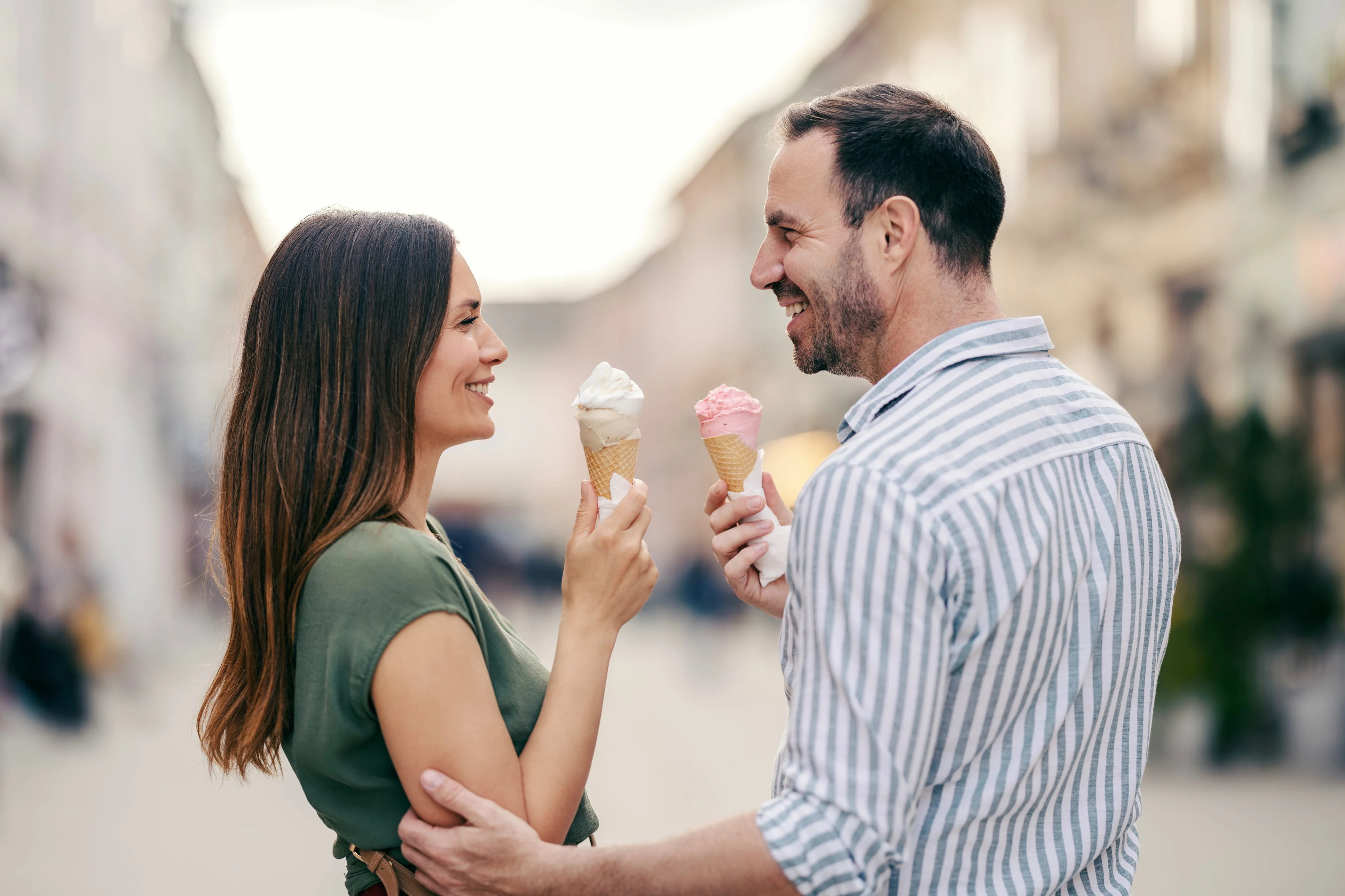 Happy couple walking together with ice cream