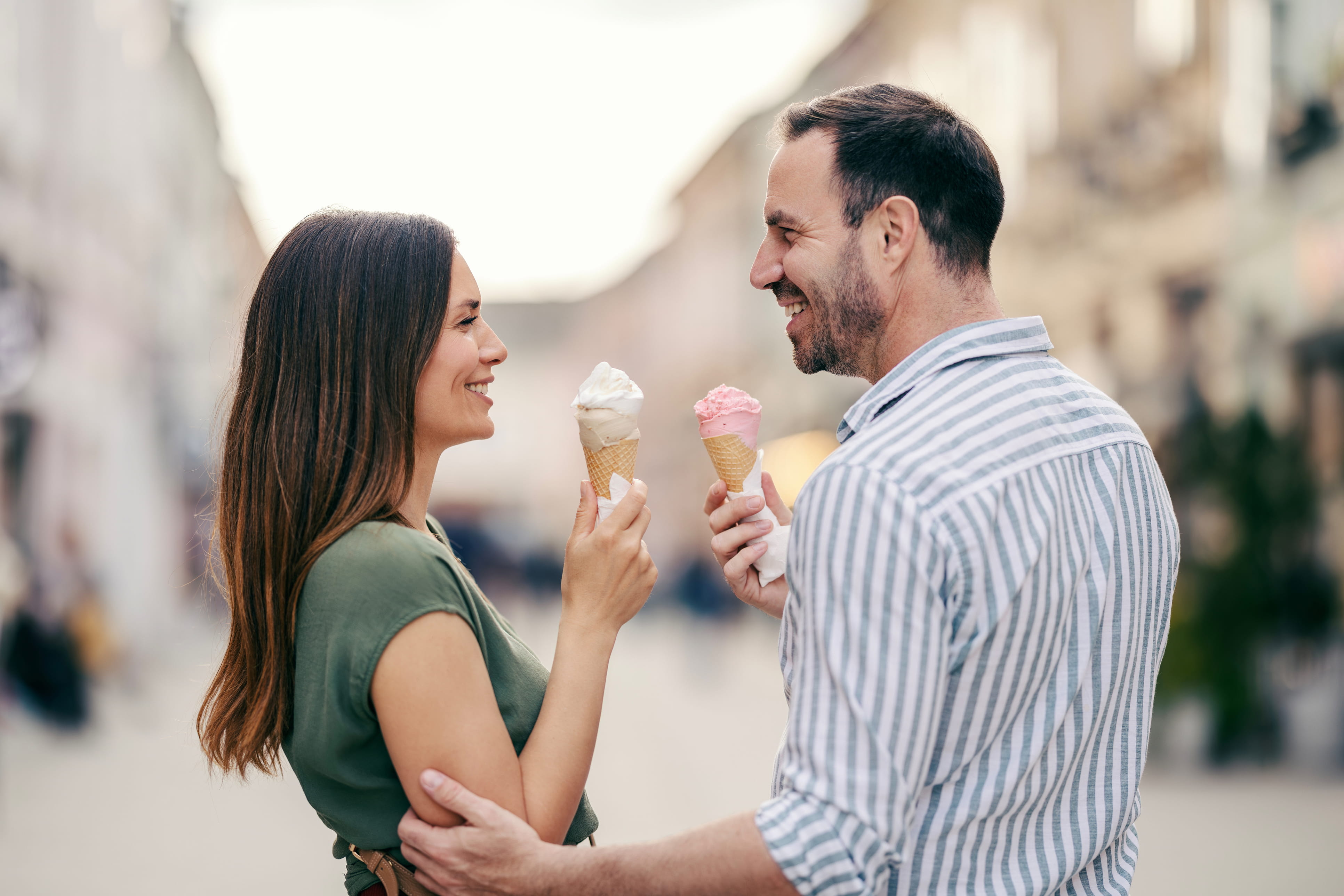 Happy couple walking together with ice cream